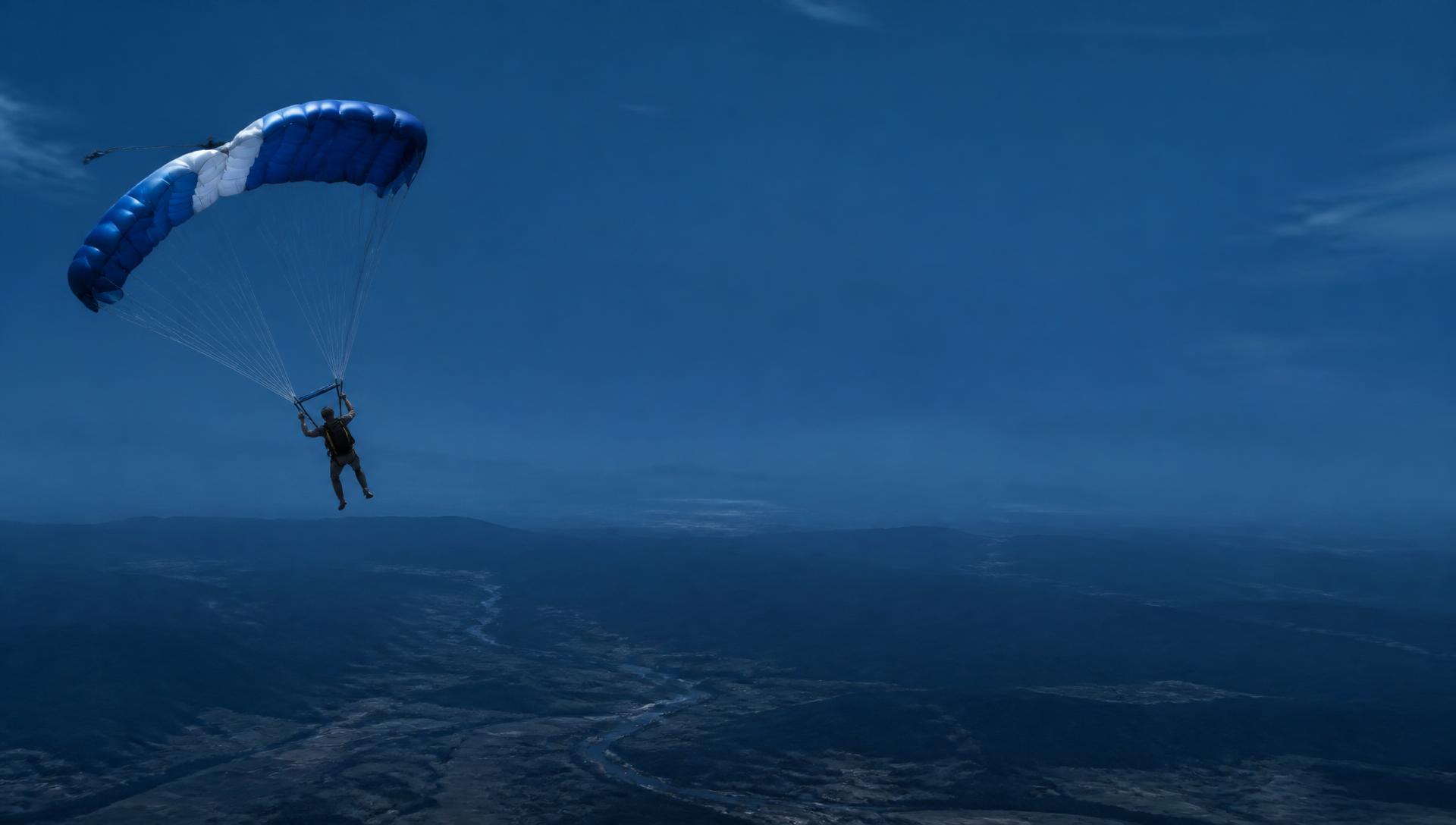 Skydiver under canopy at sunset